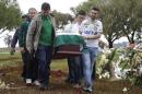 Friends and relatives carry the coffin with the remains of Chapecoense soccer team's late president Sandro Pallaoro, who died in a plane crash in Colombia, at his burial in Chapeco, Brazil, Sunday, Dec. 4, 2016. The accident Monday in the Colombian Andes claimed most of the team's players and staff as it headed to the finals of one of Latin America's most important club tournaments. (AP Photo/Andre Penner)