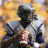 West Virginia quaterback Geno Smith (12) looks for a receiver during the first half of an NCAA college football game against Maryland in Morgantown, W.Va., Saturday, Sept. 22, 2012. (AP Photo/Christopher Jackson)