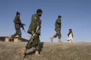 Afghan National Army and U.S. soldiers walk on patrol in the town of Shah joy in Zabul province, southern Afghanistan