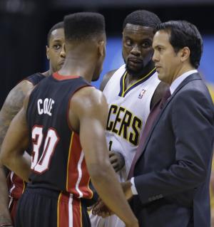 Indiana Pacers guard Lance Stephenson (1) joins a huddle as Miami Heat head coach Erik Spoelstra talks to Mario Chalmers, left and Norris Cole (30) during the second half of Game 5 of the NBA basketball Eastern Conference finals in Indianapolis, Wednesday, May 28, 2014. (AP Photo/Michael Conroy)