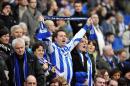 Brighton & Hove Albion's fans sing in the crowd ahead of a match in Brighton, southern England on January 5, 2013