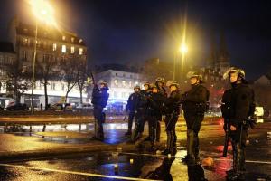 Riot police stand guard during a demonstration for …