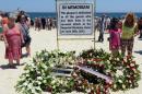Tourists and Tunisians take part in a ceremony on July 3, 2015, in memory of those killed the previous week by a jihadist gunman in front of the Riu Imperial Marhaba Hotel in Port el Kantaoui