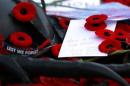Poppies, notes, and mementoes are placed on the Tomb of the Unknown Soldier following Remembrance Day ceremonies at the National War Memorial in Ottawa