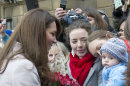 FILE - In this Wednesday Nov. 28, 2012 file photo Britain's Kate Duchess of Cambridge. left. meets with a young member of the public as she arrives at the Guildhall during a visit to Cambridge England. Prince William's wife Kate has been admitted to the hospital in early stages of labor it was announced on Monday July 22, 2013. (AP Photo/Arthur Edwards, File)