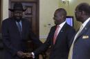 South Sudan's President Salva Kiir (L) welcomes Nigeria's acting Foreign Minister Nurudeen Mohammed at his office in Juba on December 22, 2013