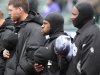 Colorado Rockies' Eric Young Jr., center, and others try to keep warm in below-freezing weather before the first baseball game of a doubleheader against the Atlanta Braves, Tuesday, April 23, 2013, in Denver. The Braves won 4-3. (AP Photo/Barry Gutierrez)