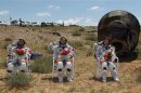 Chinese astronauts Jing Haipeng, Liu Wang and Liu Yang, China's first female astronaut, salute in front of the re-entry capsule of China's Shenzhou 9 spacecraft in Siziwang Banner, Inner Mongolia Autonomous Region