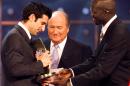 FILE - In this Monday, Dec. 17, 2001 file photo, Portuguese player Luis Figo, left, of Spanish team Real Madrid receives his trophy as FIFA "World Player of The Year 2001" from Swiss FIFA president Joseph Blatter, center, and Georges Weah of Liberia, right, during the awards ceremony of the FIFA trophies in Zurich, Switzerland. Luis Figo said in an interview on Tuesday, Jan. 27, 2015 that he wants to become FIFA president and has the nominations needed to be an official candidate against Sepp Blatter. (AP Photo/Keystone, Michele Limina, File)
