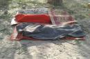 Bodies covered with blankets are pictured on January 17, 2017 after an an air force jet accidentally bombarded a camp for displaced people in northeast Nigeria