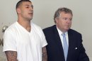 FILE - In this June 26, 2013, file photo, Aaron Hernandez, left, stands with his attorney, Michael Fee, right, during arraignment in Attleboro District Court in Attleboro, Mass. Since Hernandez was arrested last week in the shooting death of a friend whose body was found a mile away from his home, a portrait has emerged of a man whose life away from the field included frequent connections with police-related incidents that started as long ago as his freshman year at the University of Florida. (AP Photo/The Sun Chronicle, Mike George, Pool)