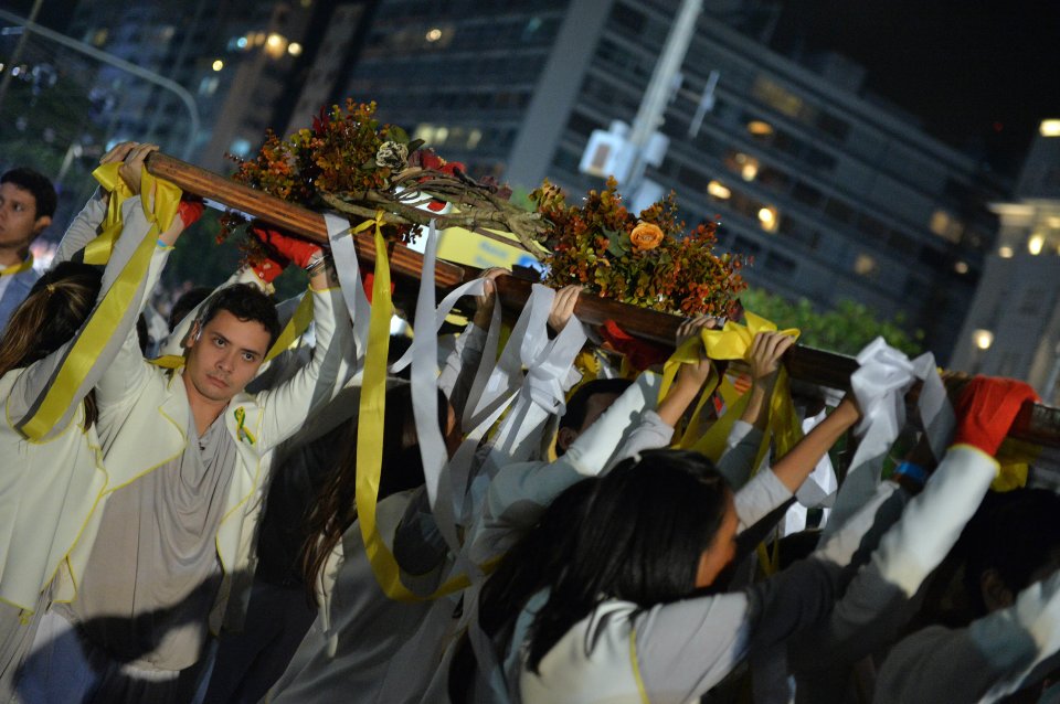 The World Youth Day Cross is carried by youth during the Stations of the Cross service, on the Copacabana beachfront in Rio de Janeiro, Brazil, Friday, July 26, 2013. Pope Francis presided over one of the most solemn rites of the Catholic Church on Friday, a procession re-enacting Christ's crucifixion, that received a Broadway-like treatment; staging a wildly theatrical telling of the Stations of the Cross, complete with huge stage sets, complex lighting, a full orchestra and a cast of hundreds acting out a modern version of the biblical story. (AP Photo/Luca Zennaro, Pool)