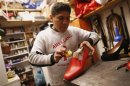 Shoemaker Arellano works on a red shoe he made for Pope Benedict XVI in his shop in downtown Rome