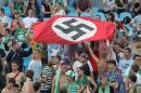 In this photo taken Aug. 19, 2007 soccer fans show a German Nazi flag with a swastika during an Ukrainian League Championship soccer match between Dynamo Kyiv and Karpaty in Kiev, Ukraine. With the defeat of Adolf Hitler in 1945, the Nazi's scarlet flag with a black swastika was banned in Germany and remains so today. The banner once hung from all official buildings in the Third Reich, was waved madly by the cheering crowds that supported Hitler and the Nazis, and was an integral part of military and other uniforms. Synonymous with the genocidal policies of the Nazis, the flag, the swastika and all other such symbols are illegal to display today, but remain favorites of neo-Nazis and other right-wing extremists, both inside Germany and around the world. After the war, the swastika was chiseled out of the talons of the stylized stone eagle that featured on many Nazi buildings, but today there is now a debate about whether the bird itself should go as well. (Ukrinform via AP)