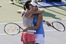 Martina Hingis, right, hugs Flavia Pennetta after the two defeated Cara Black and Sania Mirza in a semifinal doubles match of the 2014 U.S. Open tennis tournament, Thursday, Sept. 4, 2014, in New York. (AP Photo/Charles Krupa)