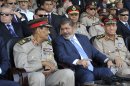 In this photo released by the office of the Egyptian Presidency, President Mohammed Morsi, second from right, talks with Field Marshal Hussein Tantawi, second left, as they attend a military graduation ceremony with Prime Minister Kamal el-Ganzouri, left, and Chief of Staff Sami Anan, right, in Cairo, Egypt, Tuesday, July 17, 2012. Egypt's President Mohammed Morsi hailed the Egyptian army and its commanders at a time the newly elected Islamist president and the military council, which took power after ouster of Hosni Mubarak last year, are in mid of power struggle. (AP Photo/Sheriff Abd El Minoem, Egyptian Presidency)