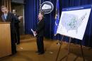 U.S. Deputy Attorney General Cole points to map of cleanup sites during an announcement of a settlement with Anadarko Petroleum Corp in Washington