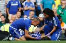 Chelsea doctor (R) Eva Carneiro and head physio Jon Fearn (L) treat Chelsea's Belgian midfielder Eden Hazard during the English Premier League football match between Chelsea and Swansea City at Stamford Bridge in London on August 8, 2015
