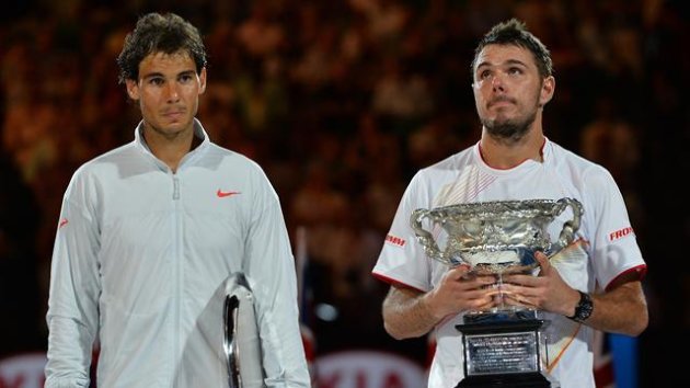 Switzerland's Stanislas Wawrinka (R) holds the trophy after his victory against Spain's Rafael Nadal (Getty Images)