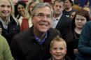 U.S. Republican presidential candidate Jeb Bush takes a picture with a young boy after speaking during a campaign event in Sumter