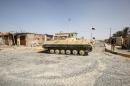 An Iraqi government forces tank is positioned in the middle of the road as they secure the town of Sharqat, around 80 kilometres (50 miles) south of the city of Mosul, on September 23, 2016