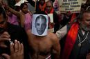A right-wing Indian Hindu activist wearing a mask depicting US President Barack Obama takes part in a protest near the US Embassy in New Delhi on December 18, 2013