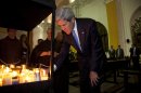U.S. Secretary of State John Kerry lights a candle during his visit to San Francisco Church in Antigua Guatemala, Tuesday, June 4, 2013. Kerry is in Guatemala for the annual general assembly of the Organization of American States (OAS). (AP Photo/Moises Castillo)