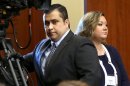 FILE - In this Monday, June 24, 2013 file photo, George Zimmerman, left, arrives in Seminole circuit court with his wife, Shellie, on the 11th day of his trial, in Sanford, Fla. George Zimmerman's wife filed for divorce Thursday, Sept. 5, 2013 less than two months after her husband was acquitted of murdering Trayvon Martin and a week after she pleaded guilty to perjury in his case. (AP Photo/Orlando Sentinel, Joe Burbank, Pool, File)