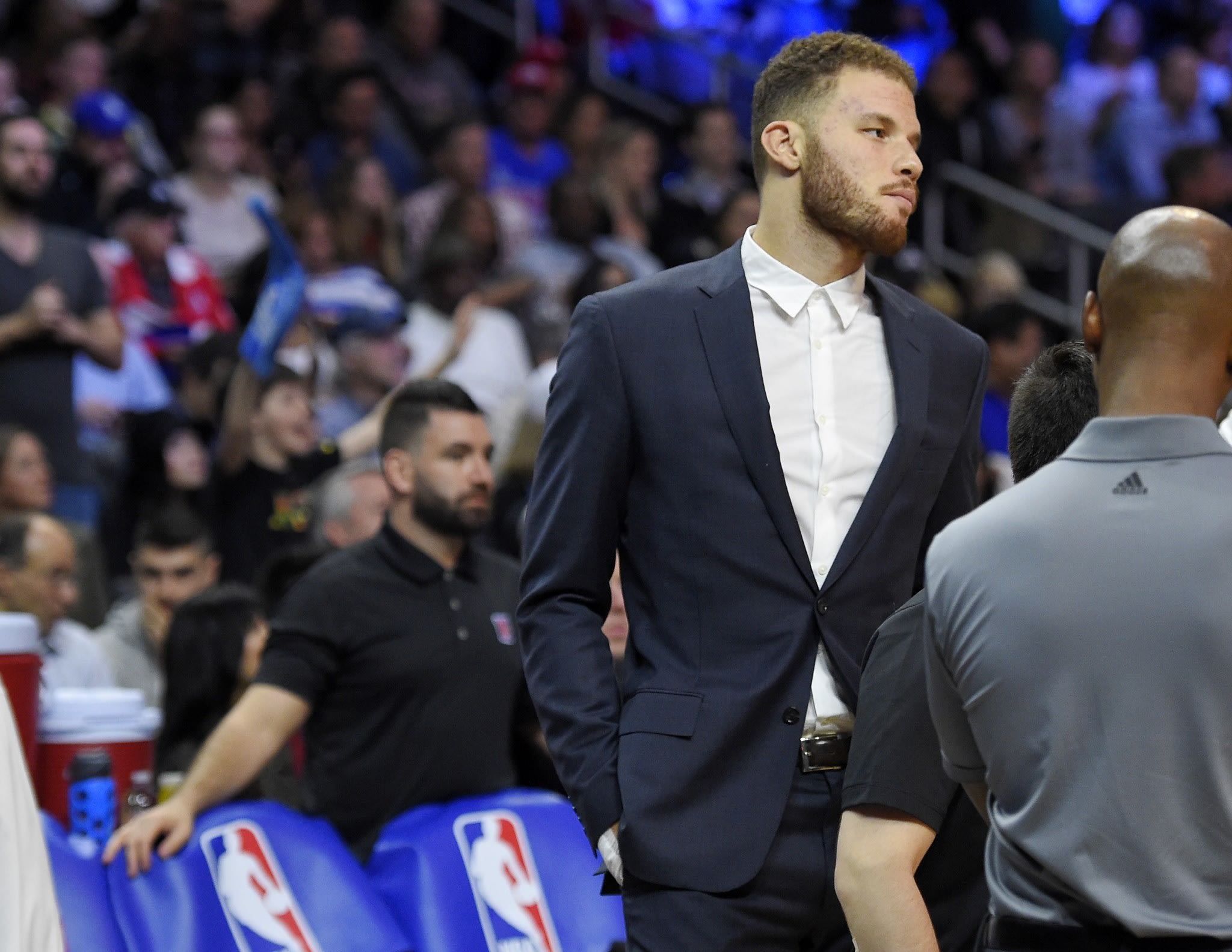Blake Griffin stands on the court as Clippers equipment manager Matias Testi (left) stands behind the bench during a Feb. 18, 2016, game. (AP/Mark J. ...