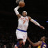 New York Knicks forward Carmelo Anthony (7) goes up for a layup over Los Angeles Lakers guard Chris Duhon (21) in the first half of their NBA basketball game at Madison Square Garden in New York, Thursday, Dec. 13, 2012.  The Knicks defeated the Lakers 116-107. (AP Photo/Kathy Willens)