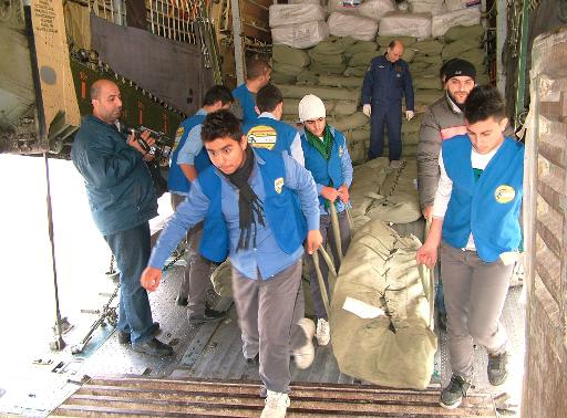 Arab News Agency (SANA) on December 10, 2013, shows workers offloading humanitarian aid from a Russian aircraft at the al-Basel airport in the Syrian coastal city of Latakia