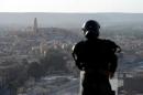 A member of the Algerian security forces stands guard on a ridge looking down on the Algerian city of Ghardaia on March 18, 2014