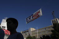 <p> A protester leaves the headquarters of Greek state broadcaster , ERT, in Athens, on Sunday, June 16, 2013. Greece's fragile governing coalition failed to reach a compromise Wednesday about the closure of the state-run ERT broadcaster, that has left the government in a crisis that could lead to early elections, just a year after it was formed to save the country from bankruptcy. (AP Photo/Kostas Tsironis)