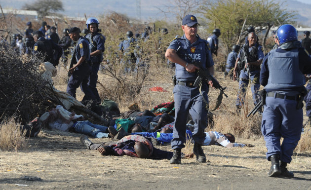 Police surround the bodies of striking miners after opening fire on a crowd  at the Lonmin Platinum Mine near Rustenburg, South Africa, Thursday, Aug. 16, 2012. An unknown number of people have been k