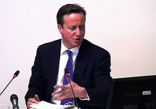 A video grab from footage taken inside the Leveson Inquiry shows David Cameron giving evidence Thursday