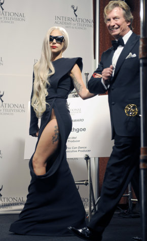 Lady Gaga, left, and producer Nigel Lythgoe arrive in the press room after she presented him with the Founders Award at the 39th International Emmys, on Monday, Nov. 21, 2011, in New York. (AP Photo/Henny Ray Abrams)