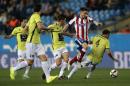 Atletico's Saul duels for the ball with Hospitalet's Jose, right, during a King's Cup soccer match between Atletico de Madrid and Hospitalet, at the Vicente Calderon stadium in Madrid, Spain, Thursday, Dec. 18, 2014 . (AP Photo/Daniel Ochoa de Olza)