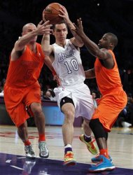 Los Angeles Lakers guard Steve Nash (10) drives between New York Knicks guards Jason Kidd (5) and Raymond Felton (2) during the first half of their NBA basketball game in Los Angeles, Tuesday, Dec. 25, 2012. (AP Photo/Alex Gallardo)