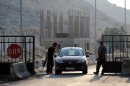 Syrian gunmen open the Bab al-Hawa border gate between Turkey and Syria on July 21