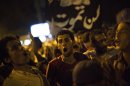 Supporters of Egypt's ousted President Mohammed Morsi chants slogans against the Egyptian Army after "Iftar" during a protest near Cairo University in Giza, Egypt, Sunday, Aug. 4, 2013. (AP Photo/Manu Brabo)