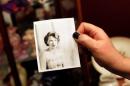 Lisa Stauffer holds a photo of her late mother-in-law Doris Stauffer, taken when she was 16 years old, in Surprise