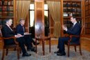 Syrian President Bashar al-Assad speaks during an interview with former Rep. Dennis Kucinich and Fox News correspondent Greg Palkot on Sept. 19.