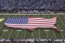 FILE - In this Sunday, Nov. 8, 2009 file photo, a U.S. flag in the shape of the continental United States is displayed on the field of Lucas Oil Stadium before an NFL football game between the Indianapolis Colts and the Houston Texans in Indianapolis. Marc Leepson, author of "Flag: An American Biography," agrees. "We don't have a monarch or a state religion," he says. "In some ways, the flag is a substitute." (AP Photo/AJ Mast)