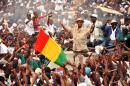Guinean opposition presidential candidate Cellou Dalein Diallo (C) waves to supporters on October 8, 2015 during a campaign rally in Conakry