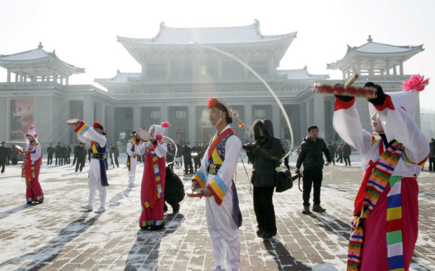 North Korean youths in traditional Korean outfit play instruments in front of the Pyongyang Grand Theatre in Pyongyang, North Korea, to celebrate a rocket launch on Wednesday, Dec. 12, 2012. North Korea appeared to successfully fire a long-range rocket Wednesday, defying international warnings as the regime of Kim Jong Un pushes forward with its quest to develop the technology needed to deliver a nuclear warhead. (AP Photo/Jon Chol Jin)