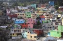 In this picture taken March 21, 2013, homes painted in bright colors cover a hill in Jalousie, a cinder block shantytown in Petionville, Haiti. Workers this month began painting the concrete facades of buildings in Jalousie slum a rainbow of colors, inspired by the dazzling 
