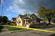 The family house of Gina DeJesus, one of the three women which were held captive for a decade, is decorated by well wishers on May 7, 2013 in Cleveland, Ohio. US police searched an unremarkable home in a working-class neighborhood of Cleveland on Tuesday after three women who had been missing for around a decade were rescued from kidnappers