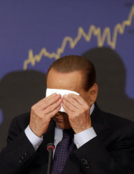 FILE - In this Sept. 27, 2012 file photo, Italian former premier Silvio Berlusconi wipes his forehead during a press conference in Rome, Italy. A court in Italy has convicted, Friday, Oct. 26,
   2012,
 former Premier Silvio Berlusconi of tax fraud and sentenced him to four years in
 prison. In Italy, cases must pass two levels of appeal before the verdicts are final. Berlusconi is expected to appeal. (AP Photo/Alessandra Tarantino, File)