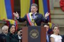 Wearing the presidential sash, newly sworn-in President Juan Manuel Santos, delivers his inaugural speech, in Bogota, Colombia, Thursday, Aug. 7, 2014. Santos, who narrowly defeated a conservative challenger to win another term, promises to redouble his efforts to end a half-century war against Marxist rebels. (AP Photo/Fernando Vergara)