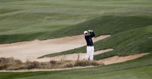 Simon Dyson of Britain hits out of a sand trap on the seventh hole during the BMW Masters 2013 golf tournament in Shanghai